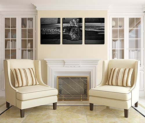 Living room with two chairs, fireplace, and motivational wall art.