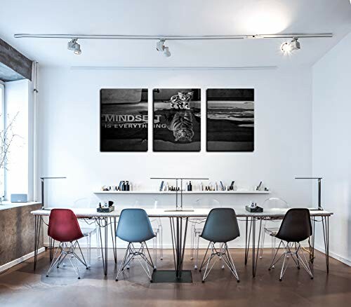 Modern office with chairs, table, and motivational wall art.