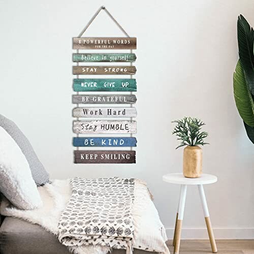 Decorative wall sign with motivational phrases in living room.